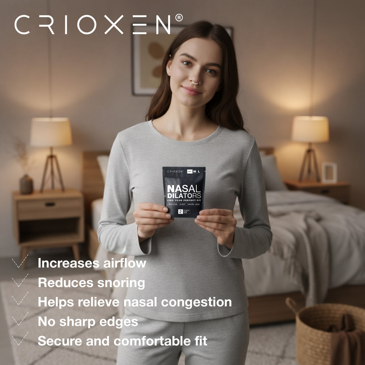CRIOXEN Nasal Dilator for Easier Nasal Breathing and Better Sleep. Reusable Anti-Snoring Device. Helps Improve Airflow, Open Nasal Passages, Reduce Snoring and Support Sports Performance. A Woman Stands in a Softly Lit Bedroom Holding a Small Black Package of Nasal Dilators.